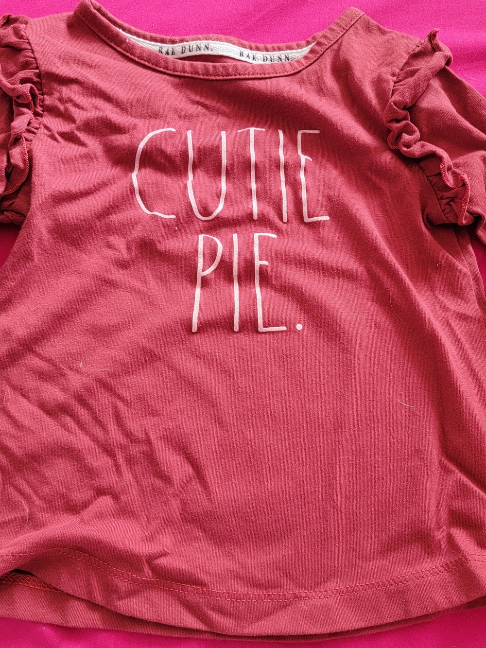 Rae Dunn Burgundy Ruffle Sleeve "Cutie Pie" Top.